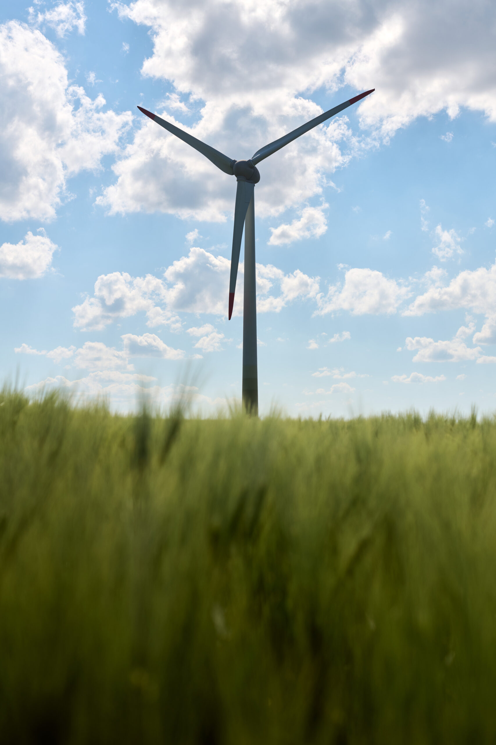 Silhouetted wind turbine with cloudy sky